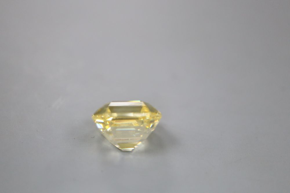 An unmounted emerald cut yellow gemstone, possibly cubic zirconia, weighing approximately 29.00ct.